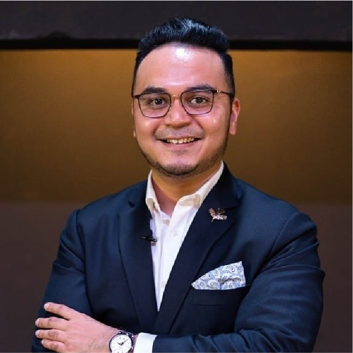 Alfred Netto, Founder and Principal Advisor of Nextalent, in a navy suit with his arms folded